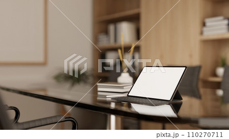 A white-screen digital tablet with a wireless keyboard on a meeting table in a modern meeting room. A white-screen digital tablet with a wireless keyboard on a meeting table in a modern meeting room. 110270711