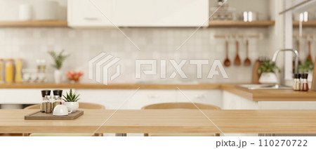 Copy space for displaying your product on a wooden dining table in a minimalist Scandinavian kitchen 110270722