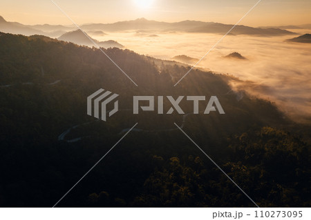 Aerial view of road in mountain valley at sunrise Aerial view of road in mountain valley at sunrise 110273095