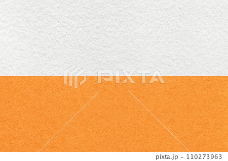 Texture of craft white and orange paper background, half two colors, macro. Structure of vintage ginger cardboard. Texture of craft white and orange paper background, half two colors, macro. Structure of vintage ginger cardboard. 110273963