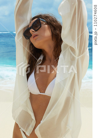 emotion Beautiful young woman on the beach. Happy girl in Sunglasses 110274608