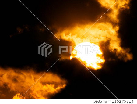 Beautiful nature sky with orange, yellow sunshine and fluffy clouds. Time lapse of a beautiful dramatic sky with a big sun at sunset or sunrise. Beautiful nature sky with orange, yellow sunshine and fluffy clouds. Time lapse of a beautiful dramatic sky with a big sun at sunset or sunrise. 110275514