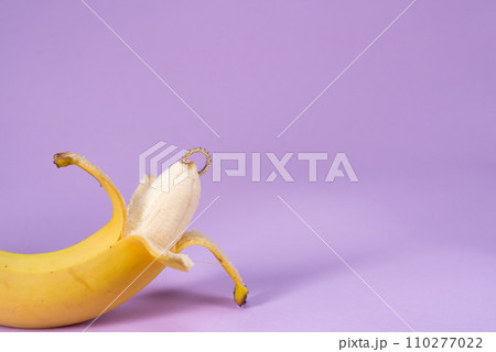 Intimate piercing. Minimal piercing concept. Banana with inserted iron decoration, piercing Intimate piercing. Minimal piercing concept. Banana with inserted iron decoration, piercing 110277022