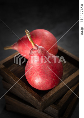 Red pear on wooden background 110277650