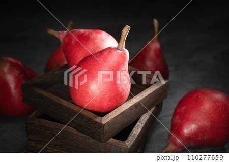 Red pear on wooden background 110277659