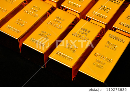 Close up photo a gold bar on black background 110278626