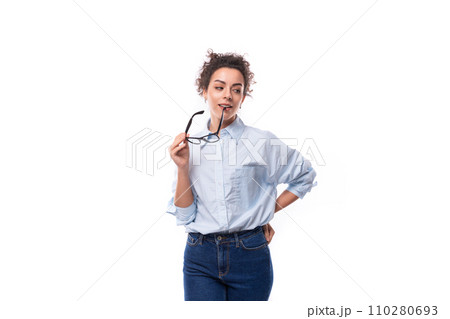 portrait of a young successful confident leader woman with curly black hair in an office elegant 110280693