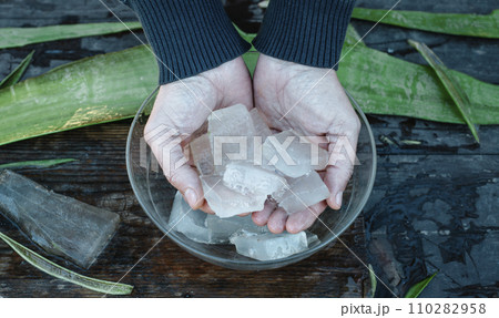 man puts some pieces of aloe vera gel in a bowl 110282958