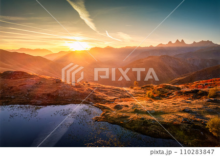 French Alps landscape of sunrise shines over Lac Guichard with Arves massif in autumn at Aiguilles d'Arves, France 110283847