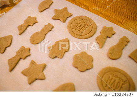Process of making heart-shaped gingerbread for Christmas and New Year. Traditional festive food making, family culinary. Process of making heart-shaped gingerbread for Christmas and New Year. Traditional festive food making, family culinary. 110284237