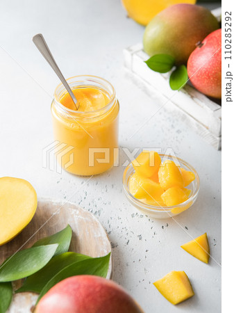 Mango puree dessert with fresh mango pieces on light background.Top view. 110285292