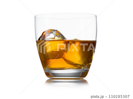 Glass of whiskey with ice cube on white background with reflection. 110285307