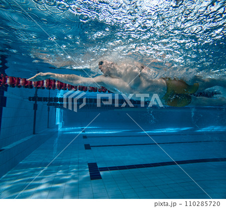 Professional swimming athlete in motion, training, practicing techniques, swimming in pool 110285720