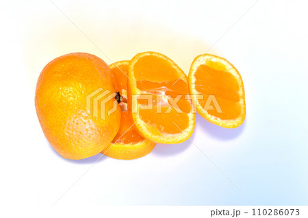 Mandarin and its slices on white. 110286073