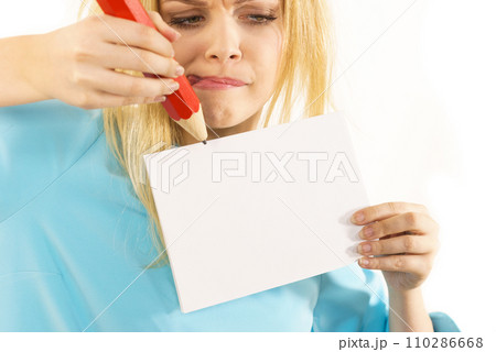 Woman with big pencil writing on paper Woman with big pencil writing on paper 110286668
