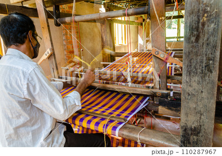 Cotton weaving on a traditional wooden handloom Cotton weaving on a traditional wooden handloom 110287967