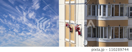 Repair work at height (sealing seams in a panel house), against the sky with clouds. Worker insulates the seams of the facade of an old residential building. Maintenance of residential buildings Repair work at height (sealing seams in a panel house), against the sky with clouds. Worker insulates the seams of the facade of an old residential building. Maintenance of residential buildings 110289744