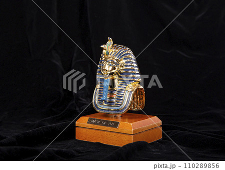 Isolated egyptian pharaoh Tutankhamun's funeral mask (Golden souvenir figurine), on black background 110289856