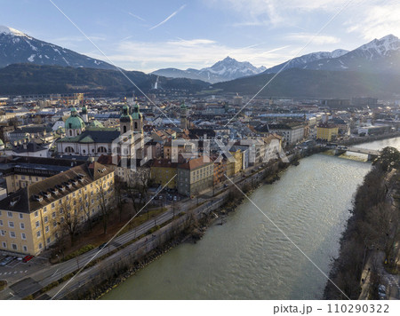 Innsbruck at evening, Aerial Drone Shot of a Beautiful winter City Skyline, Surrounded by Alps Mountains in Austria 110290322