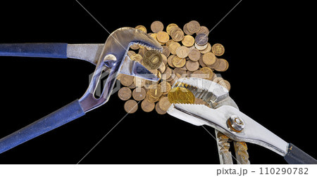 Allegory of the global financial crisis - Iron 10 rubles coin (written ten rubles, Bank of Russia in the Russian) in the grip of economic crisis, on a black background. Finance and business concept Allegory of the global financial crisis - Iron 10 rubles coin (written ten rubles, Bank of Russia in the Russian) in the grip of economic crisis, on a black background. Finance and business concept 110290782