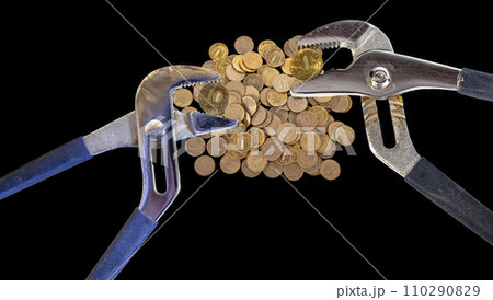 Allegory of the global financial crisis - Iron 10 rubles coin (written ten rubles, Bank of Russia in the Russian) in the grip of economic crisis, on a black background. Finance and business concept Allegory of the global financial crisis - Iron 10 rubles coin (written ten rubles, Bank of Russia in the Russian) in the grip of economic crisis, on a black background. Finance and business concept 110290829