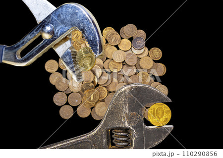 Allegory of the global financial crisis - Iron 10 rubles coin (written ten rubles, Bank of Russia in the Russian) in the grip of economic crisis, on a black background. Finance and business concept Allegory of the global financial crisis - Iron 10 rubles coin (written ten rubles, Bank of Russia in the Russian) in the grip of economic crisis, on a black background. Finance and business concept 110290856