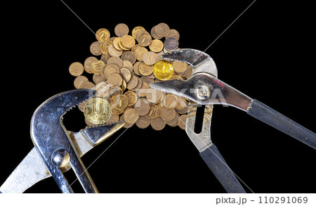 Allegory of the global financial crisis - Iron 10 rubles coin (written ten rubles, Bank of Russia in the Russian) in the grip of economic crisis, on a black background. Finance and business concept Allegory of the global financial crisis - Iron 10 rubles coin (written ten rubles, Bank of Russia in the Russian) in the grip of economic crisis, on a black background. Finance and business concept 110291069