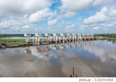 Aerial view of dam tower. Reservoir and sea water in recycle energy industry concept for electricity in Natural landscape background. Environment. Aerial view of dam tower. Reservoir and sea water in recycle energy industry concept for electricity in Natural landscape background. Environment. 110291488