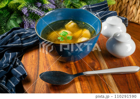 Pelmeni filled with meat served in broth. Pelmeni filled with meat served in broth. 110291590
