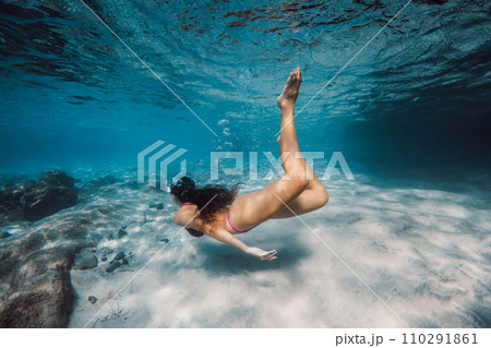 Woman swimmi ng in the tropical sea. Snorkeling with sexy woman Woman swimmi ng in the tropical sea. Snorkeling with sexy woman 110291861