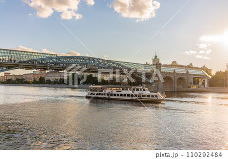 View of the Moscow river embakment, Pushkinsky bridge and cruise ships at sunset. View of the Moscow river embakment, Pushkinsky bridge and cruise ships at sunset. 110292484