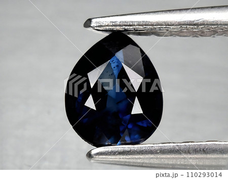 natural dark blue sapphire gem on the background natural dark blue sapphire gem on the background 110293014