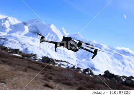 Flying drone taking picture of landscape in Tibet, China Flying drone taking picture of landscape in Tibet, China 110297820