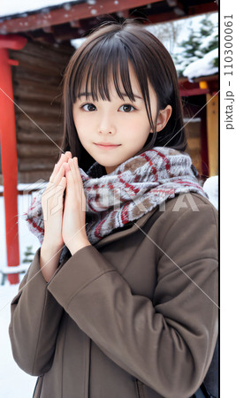 AI画像　雪の降る神社でお祈りする若い女性 110300061