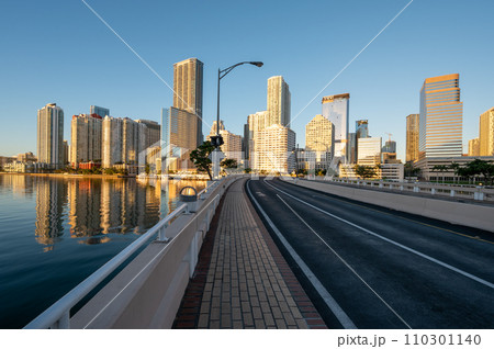 Brickell Key Bridge and City of Miami skyline at sunrise under clear blue sky. 110301140