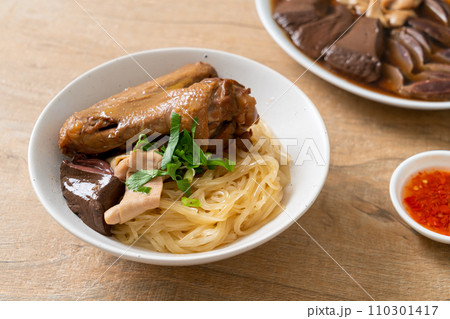 dried noodles with braised duck in white bowl 110301417