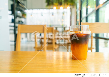 iced black coffee with yuzu cup on table iced black coffee with yuzu cup on table 110301967