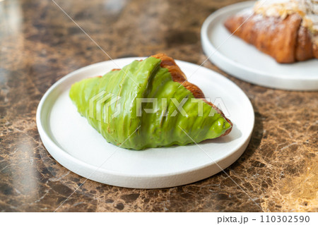 matcha green tea croissant on plate 110302590