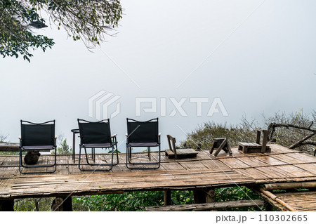 chair on balcony with mountain hill and foggy background 110302665