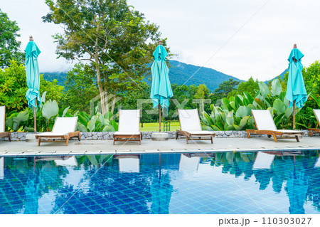 pool bed around swimming pool with mountain hill background pool bed around swimming pool with mountain hill background 110303027
