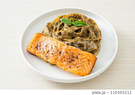pesto fettuccine spaghetti pasta with grilled salmon fillet 110303212