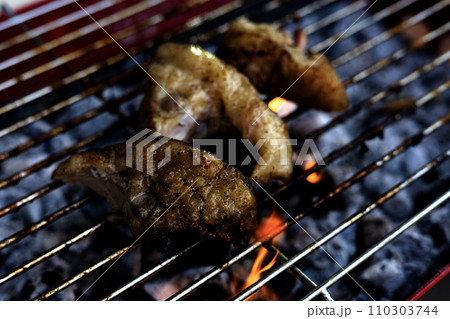 close-up of a steak on a grill. Barbecue Meat On Outdoor Grill. close-up of a steak on a grill. Barbecue Meat On Outdoor Grill. 110303744
