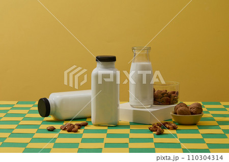 Many types of organic nuts are displayed with three milk bottles. Soybean oil is the vegetable oil extracted from the seeds of the soybean Many types of organic nuts are displayed with three milk bottles. Soybean oil is the vegetable oil extracted from the seeds of the soybean 110304314