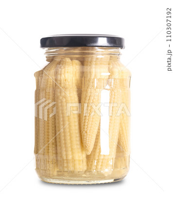 Baby corn, pickled in a glass jar. Also known as young corn, cornlettes or baby sweetcorn. Pasteurized and preserved in a brine of water, vinegar, salt and sugar. Close-up, front view, food photo. 110307192