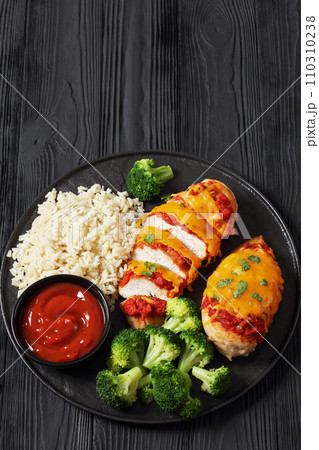 baked chicken breasts with rice, broccoli on plate 110310238