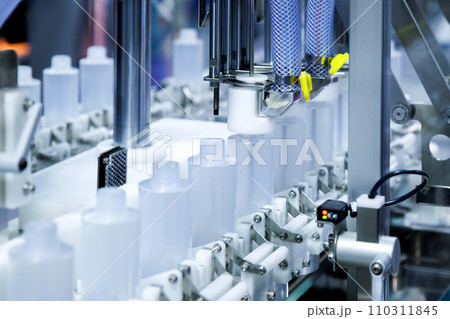 white plastic bottle moving on conveyor belt of auto capping and labeling machine at cosmetic and skin care manufacturing. cosmetic industry and ai technology machinery concept. white plastic bottle moving on conveyor belt of auto capping and labeling machine at cosmetic and skin care manufacturing. cosmetic industry and ai technology machinery concept. 110311845