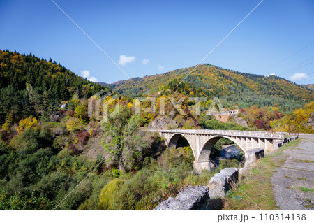 Scenic View of a Tall Bridge Crossing a River in the Mountain Range 110314138