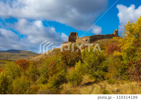 A ruined fortress in Ossetia on the hill of a mountain 110314189