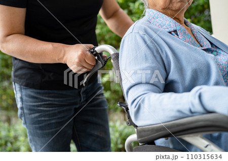Caregiver help and care Asian senior woman patient sitting on wheelchair to ramp in nursing hospital, healthy strong medical concept. 110315634