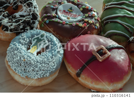 Many Glazed Doughnuts placed on wooden cutting board. Many Glazed Doughnuts placed on wooden cutting board. 110316141